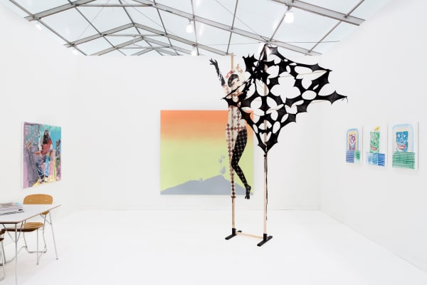 Group booth installation with gallery artists, including Anne Collier photography and Lara Schnitger's sculpture.