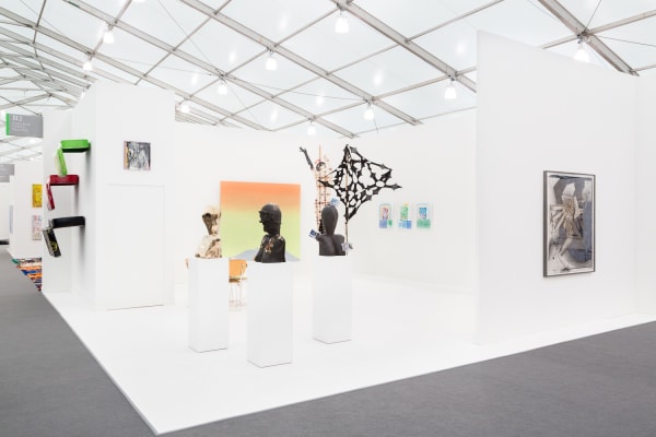 Group booth installation with gallery artists, including Anne Collier photography and Lara Schnitger's sculpture.