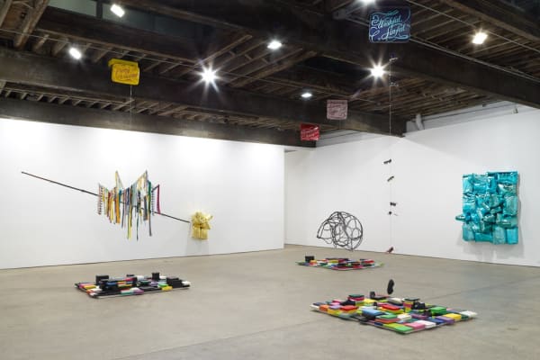 Installation view of Jim Lambie's solo exhibition. Many sculptures featured in this floor to ceiling show.