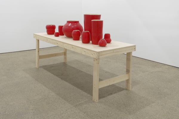 Installation view of Shio Kusaka's second show at Anton Kern Gallery, featuring a large collection of unique porcelain pots. A shot of the back gallery, showcasing Shio's red pots.