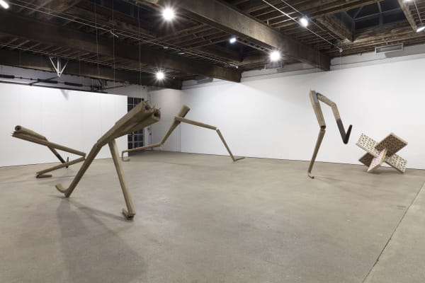 Installation view of Richard Hughes' third solo show at Anton Kern Gallery, featuring dancing lamp posts, magical garden walls, and broken memorial statues from the corners of the London suburbs. Another image of the dancing lamp post legs.