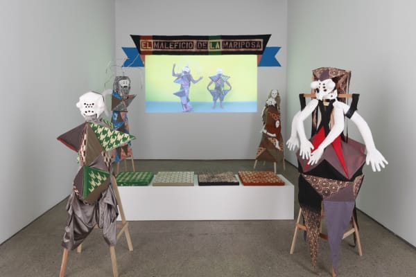 Installation view of The Butterfly's Evil Spell, a collaborative performance and installation show featuring Lara Schnitger and the LA collective My Barbarian. Figures as well as the video installation in the background.