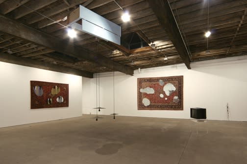 Installation view of Jim Lambie's fourth solo show at Anton Kern Gallery, consisting of five modified wall tapestries and an assemblage-like floor sculpture and video. A few of Lambie's works.