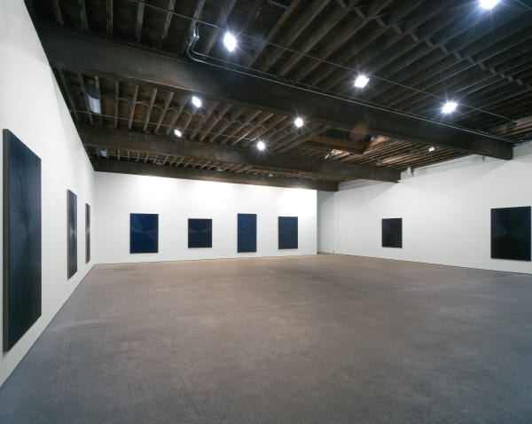 Installation view of Mark Grotjahn's second show at Anton Kern, featuring ten blue paintings descending (or ascending) in tones, shades, dynamics of blues.