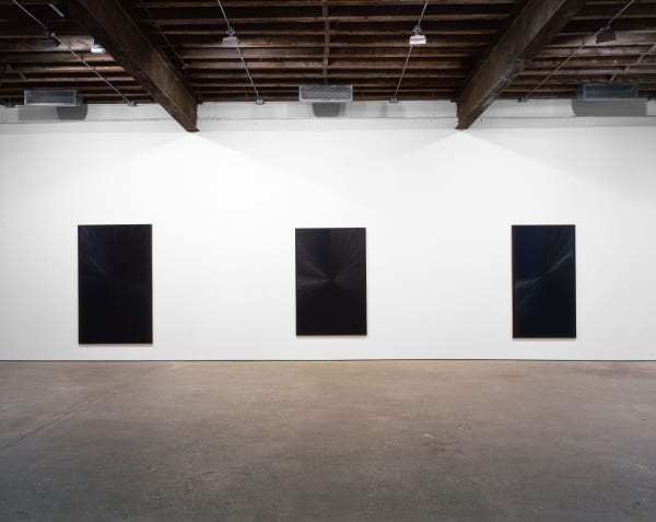 Installation view of Mark Grotjahn's second show at Anton Kern, featuring ten blue paintings descending (or ascending) in tones, shades, dynamics of blues. Three blues featured.