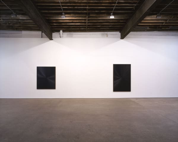 Installation view of Mark Grotjahn's second show at Anton Kern, featuring ten blue paintings descending (or ascending) in tones, shades, dynamics of blues. Two blues shown.