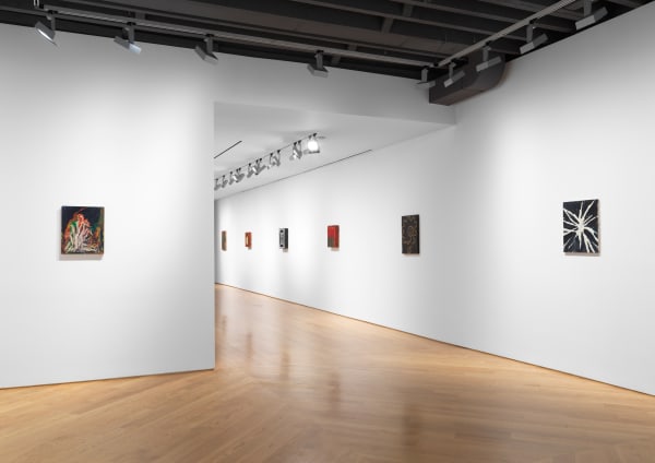 Installation views of small Chris Martin paintings on the third floor of the gallery. Many works shown.