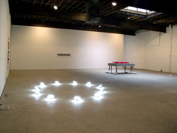 Installation view of Sinho, Marepe's first show at Anton Kern Gallery, featuring readymade sculptures and objects. Halo (2004) lights up the installation.