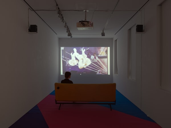 Installation view on the gallery's third floor of Erik van Lieshout's exhibition. Third floor viewing room with video playing.