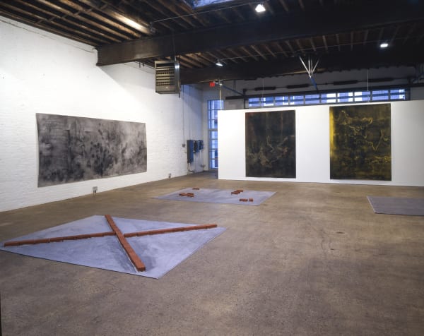Installation view of the collaborative show featuring brick works by Georg Herold and charcoal drawings by Matthew Monahan. Multiple works shown.