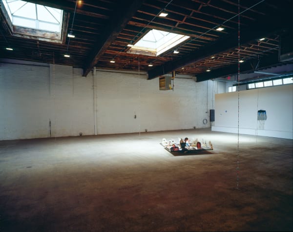 Installation view of Jim Lambie's show titled Boy Hairdresser, featuring a few sculptures, remixed vinyls, and other objects. View of gallery, Motorhead showcased in the center.