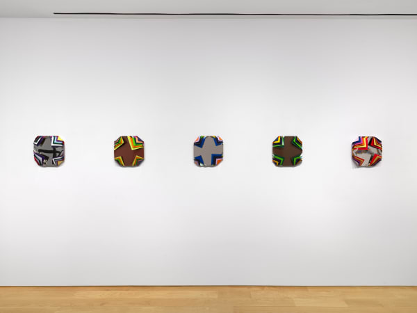 Installation view of Jim Lambie's works on the 3rd floor of the gallery featuring sunglass sculptures and metal boxes.