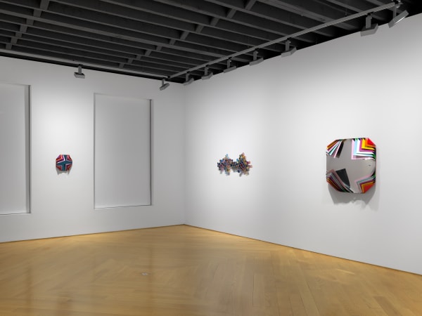 Installation view of Jim Lambie's works on the 3rd floor of the gallery featuring sunglass sculptures and metal boxes. This image shows three works.