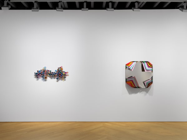 Installation view of Jim Lambie's works on the 3rd floor of the gallery featuring sunglass sculptures and metal boxes. Two works shown.