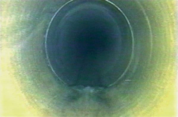 Installation view of Overflow, featured here is a still from the video installation by Fischli & Weiss.