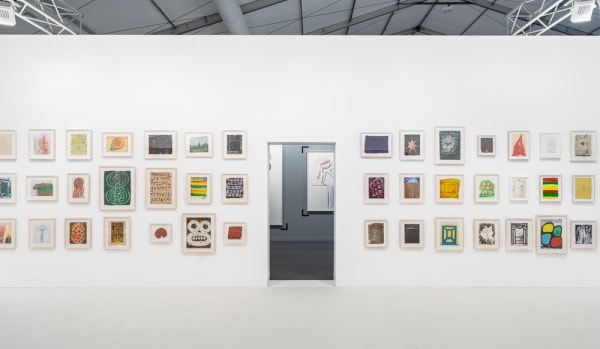 Installation view of Chris Martin's solo exhibition at Frieze London 2015. A plethora of small-scale works featured.