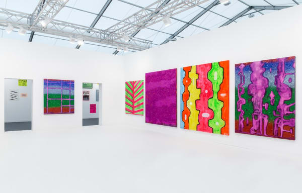 Installation view of Chris Martin's solo exhibition at Frieze London 2015. Side angle of large-scale works.