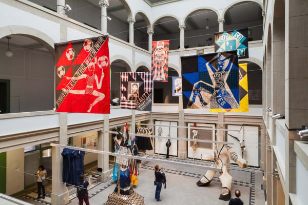 Installation view of Lara Schnitger's show at Basel Parcours, featuring a large body of works as well as a procession through Mezzeplatz. Cotton and linen works hang from the ceiling.