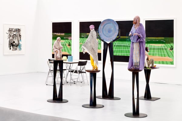 Installation view of the Anton Kern booth at Frieze New York 2013. Upritchard figures stand in front of four Jonas Wood tennis-scapes.