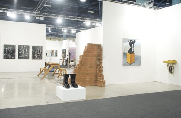 Installation view of the Anton Kern booth at Art Basel Miami 2010. Shrigley boots and a Richard Hughes site-specific brick installation.