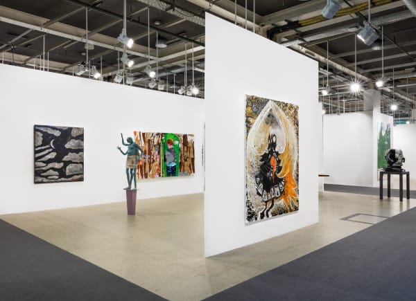 Installation view of Art Basel featuring the majority of works in the both, including sculptures, paintings, and more.