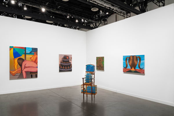 Installation view of dual booth featuring Julie Curtiss and Marepe. Julie's work is primarily paintings and Marepe's are the sculptures in the center.