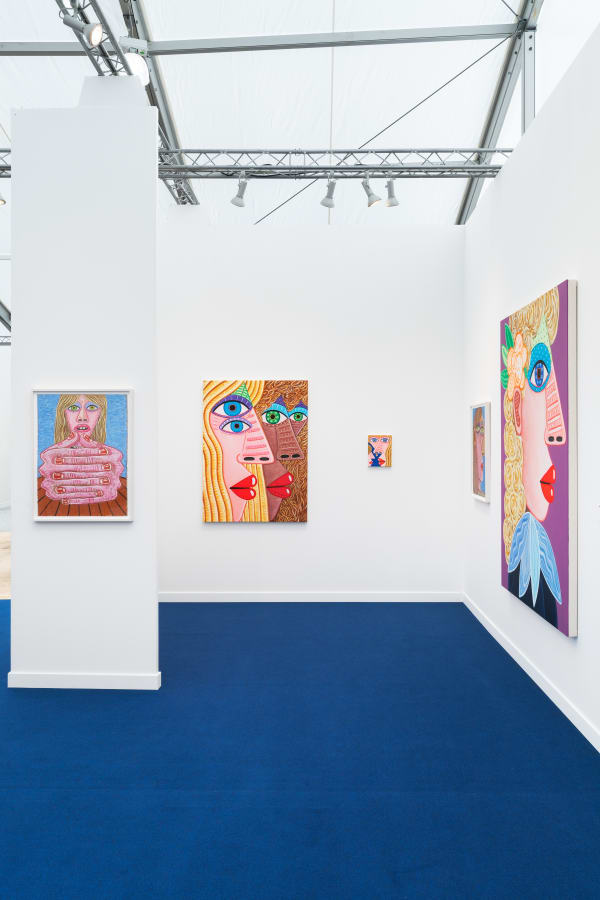 Installation view of Frieze Los Angeles 2023 booth C11 with view of blue floors, walls, artworks and ceiling.