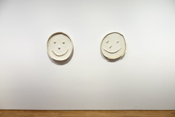 Installation view of Dan McCarthy's exhibition '7 Bangers', a group of seven ceramic sculptures with faces.