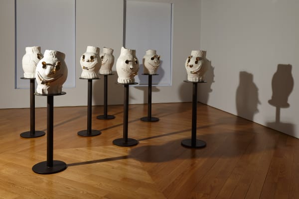 Installation view of Dan McCarthy's exhibition '7 Bangers', a group of seven ceramic sculptures with faces. Additional perspective of group of faces.