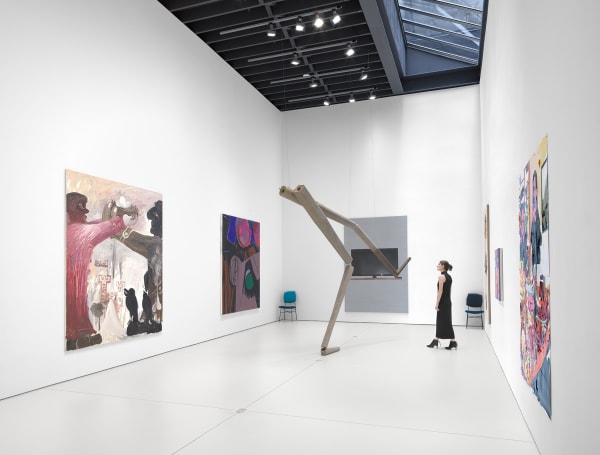 Install view floor 1. Richard Hughes, Bendix Harms, Eberhard Havekost, and more with person included for scale looking at the Hughes sculpture.