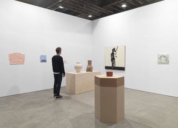 Installation view of Implosion, a 20 year anniversary show featuring all 28 artists on the Anton Kern Gallery roster. Onlooker views Sasnal's piece amongst others.