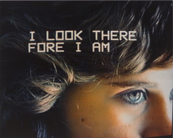Close up image of woman's face with words that read I look therefore I am.