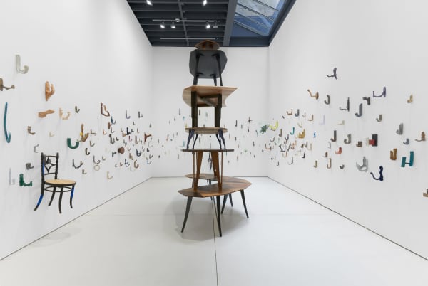 Installation view of the 2023 exhibition “Martino Gamper: I am many moods” with view of white floors, walls, artworks and ceiling.