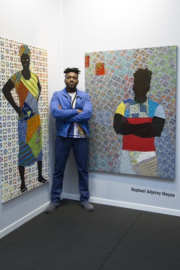 Raphael Adjetey Mayne with two of his works