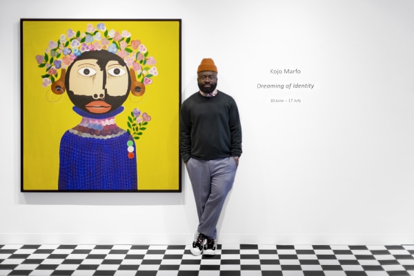Kojo Marfo standing next to a painting