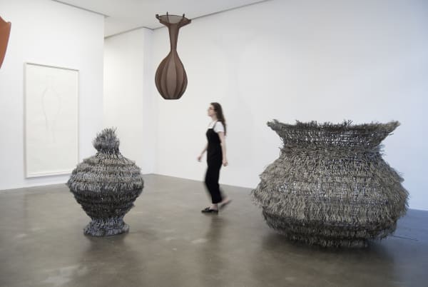 Installation views of Maren Hassinger sculptures in a Gallery with a person for scale