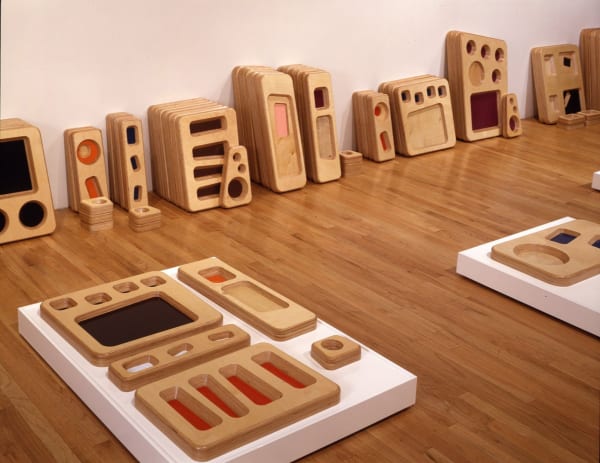 Stacks of wooden trays on the floor of Susan Inglett Gallery