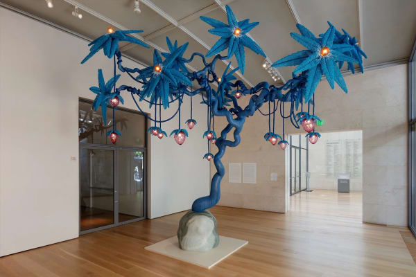 Haas Brothers, "The Strawberry Tree" (2024), cast bronze, blown glass, glass beads, Pele de Tigre marble, and light, 171 x 188 x 176 inches (434.34 x 477.52 x 447.04 cm) (artwork courtesy the artists, Marianne Boesky Gallery, New York, and Lora Reynolds Gallery, Austin; photo by Kevin Todora, courtesy the Nasher Sculpture Center)