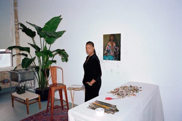 Danielle Mckinney, photographed at her Jersey City, N.J., studio on Dec. 20, 2023, in front of “She” (2023).