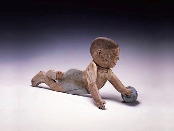 Baby and Ball Trade Sign. New York State, ca. 1925-35. Carved wood with polychrome. Featured on the cover of Ricco/Maresca Gallery's first book "American Primitive: Discoveries in Folk Sculpture" (Alfred A. Knopf, 1988).