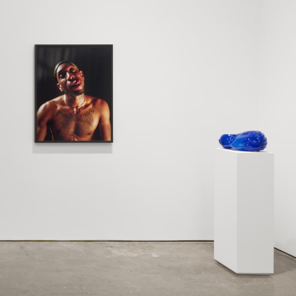 Installation View | Shikeith: grace comes violently  Featured Artworks:  Shikeith (American, b. 1981)  Prince, 2019  Archival Inkjet Print on Canson Infinity Platine 37 7/8" x 30" (96 x 76 cm) Framed: 38 3/4" x 30 7/8" (96 x 78.5 cm)  Signed, Titled, Dated and Numbered on Label  Edition of 5 Plus 2 Artist’s Proofs  Shikeith (American, b. 1981)  Beloved Blues (Oche), 2020  Blown Glass, Breath, Dreams  14” x 9” x 7” (35.6 x 22.9 x 17.8 cm)  Unique  (Shk.22213)