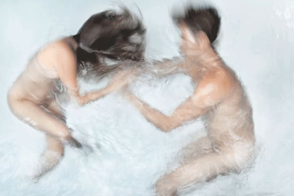 Barbara Cole photo of nude man and woman fighting underwater.