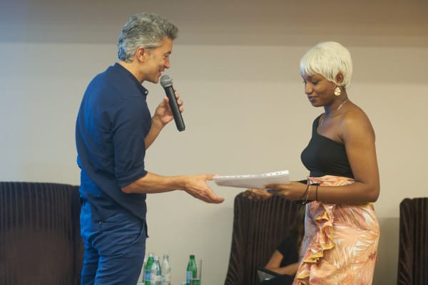 Araba Opoku receiving first prize award from founder of Gallery 1957 Marwan Zakhem