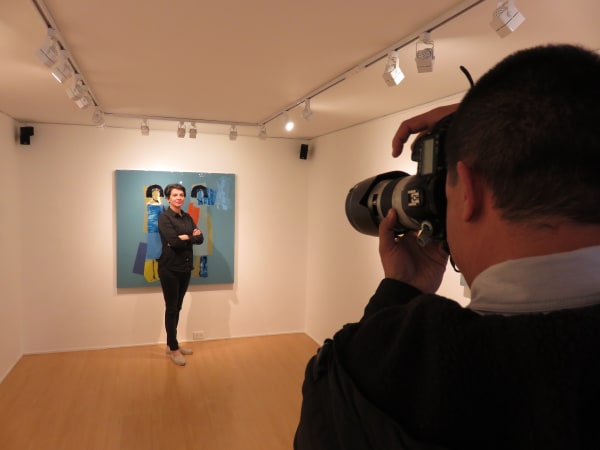 Carolina Convers poses with one of her paintings from the "Versus" Series.