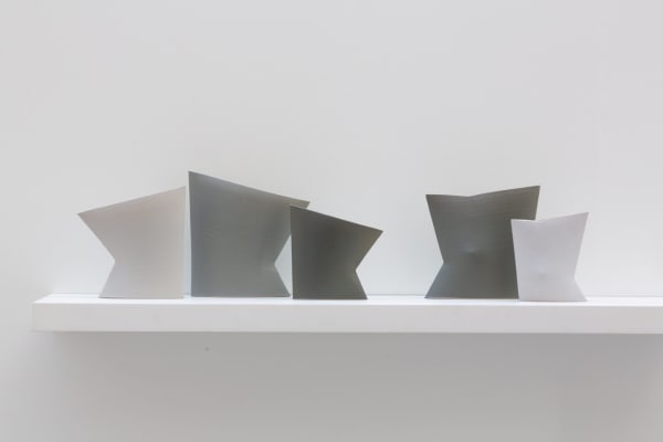 Installation of neutral coloured stoneware geometric vessels by Sun Kim, made using a series of different techniques such as wheel throwing, hand-building and assembling, 2020