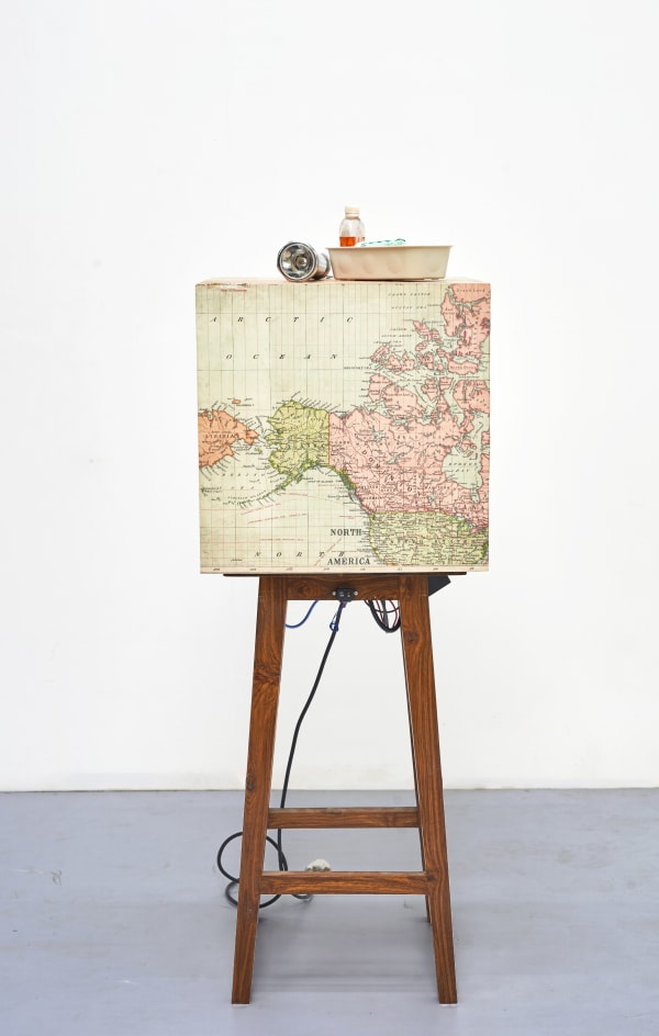 Shailesh B.R. The First Earthquake, 2015-2025 Kinetic sculpture , Concert vibrator, sensor, controllers, relay, power supply, Archival print and found Objects 53.25 x 16.25 x 16.25 in