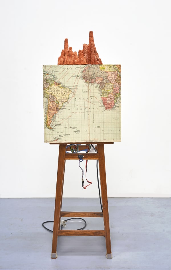 Shailesh B.R. The First Earthquake, 2015-2025 Kinetic sculpture , Concert vibrator, sensor, controllers, relay, power supply, Archival print and found Objects 53.25 x 16.25 x 16.25 in