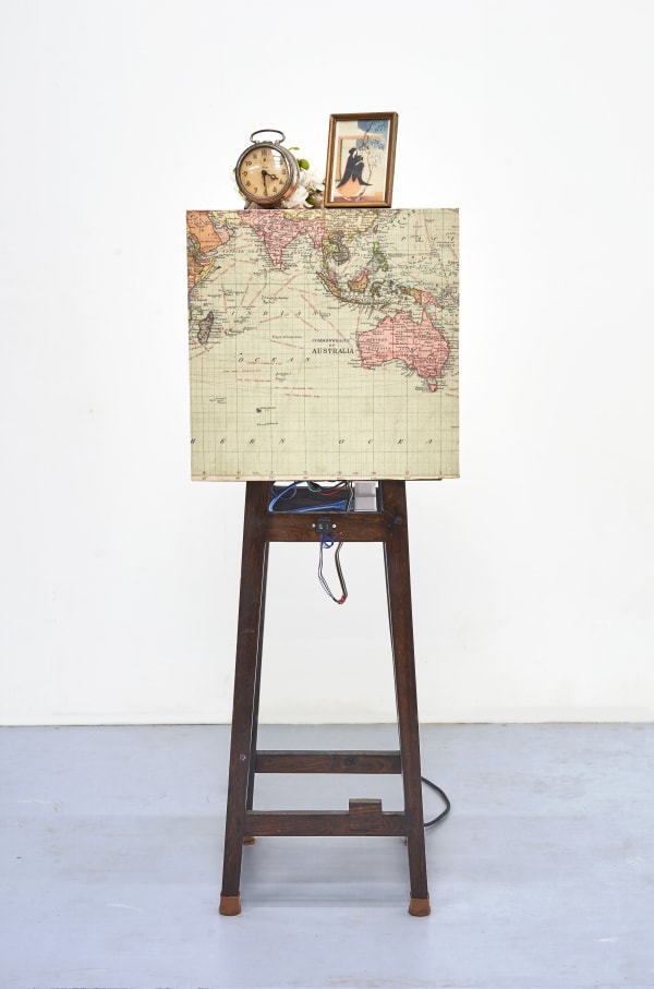 Shailesh B.R. The First Earthquake, 2015-2025 Kinetic sculpture , Concert vibrator, sensor, controllers, relay, power supply, Archival print and found Objects 53.25 x 16.25 x 16.25 in