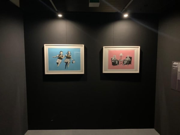 Banksy artworks hanging on wall