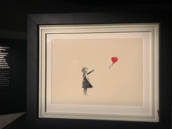 Banksy artwork hanging on wall